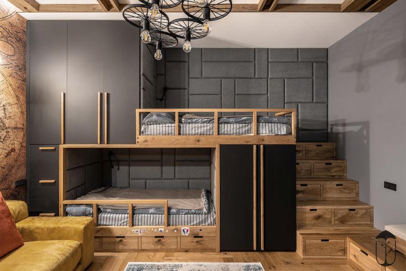 Childrens room with wooden floor gray walls and chandeliers made of bicycle wheels