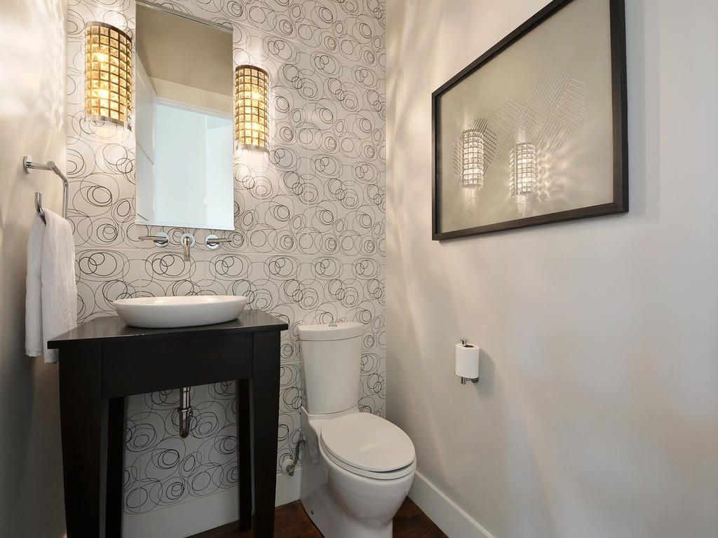 contemporary powder room with accent wall