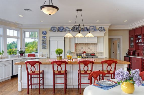 Country white kitchen plates on wall and red chairs