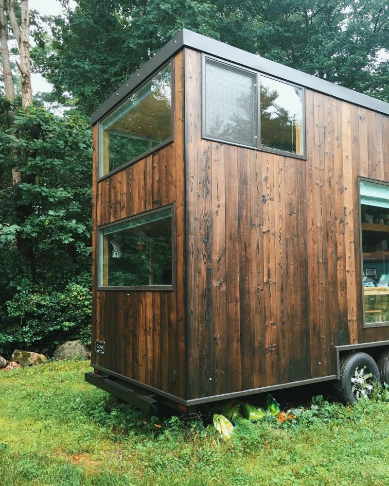 The dark cedar siding adds an elegant and homely touch to the overall design of this tiny house