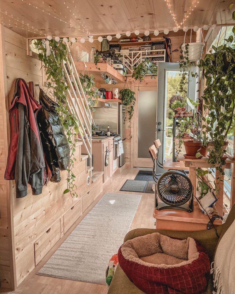 The interior is beautifully decorated with lots of hanging plants and string lights for a bohemian and cozy vibe