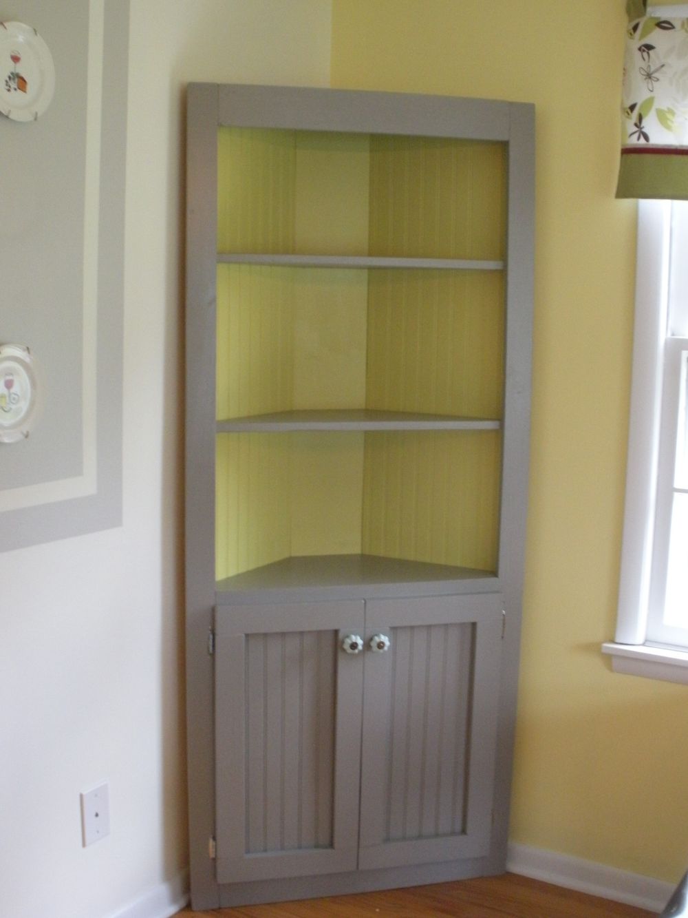 cute corner cabinet with green interior