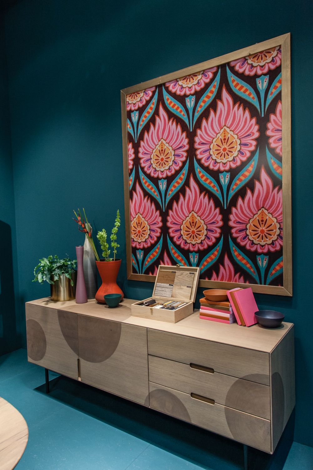 Floral leaf patterns framed above the sideboard