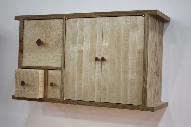 In many of his pieces, Billing uses glue-less joinery, which has been used by traditional craftsmen in Japan and China for centuries. You can see the beautiful joinery in the side of the drawer that is open.
