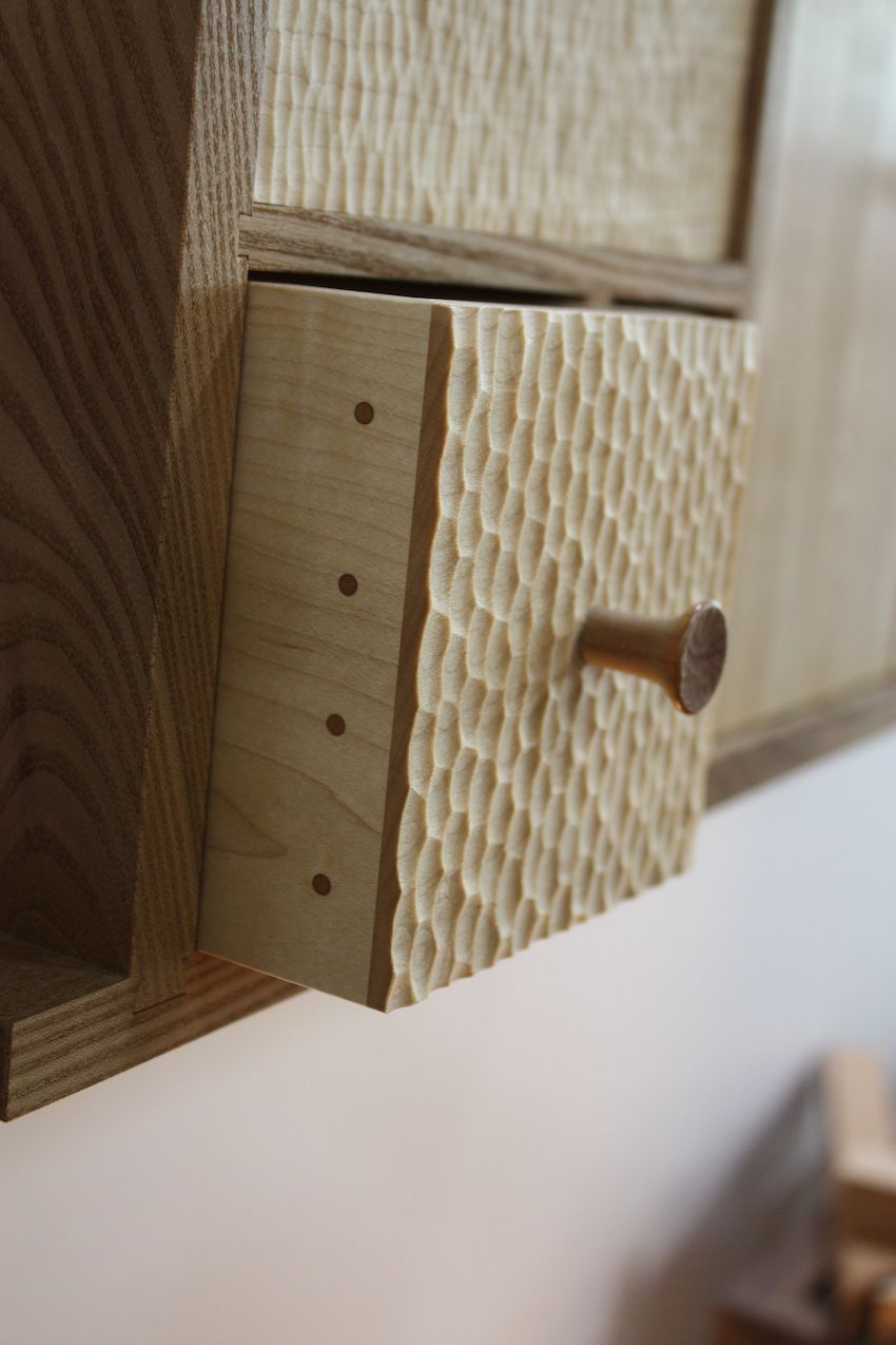 Here's a closer look at the hand-textured surface of the wood along with the glue-less joinery Billing uses. Each facet of the cabinetry is a work of art.
