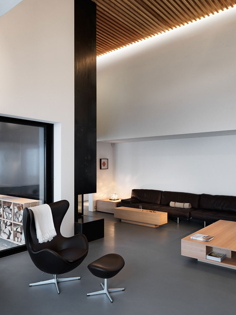 high ceiling living room with black leather egg chair