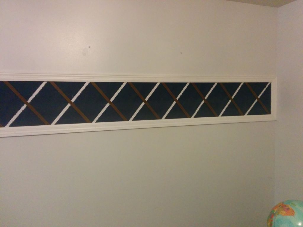 Installing wood detail x on wall 1