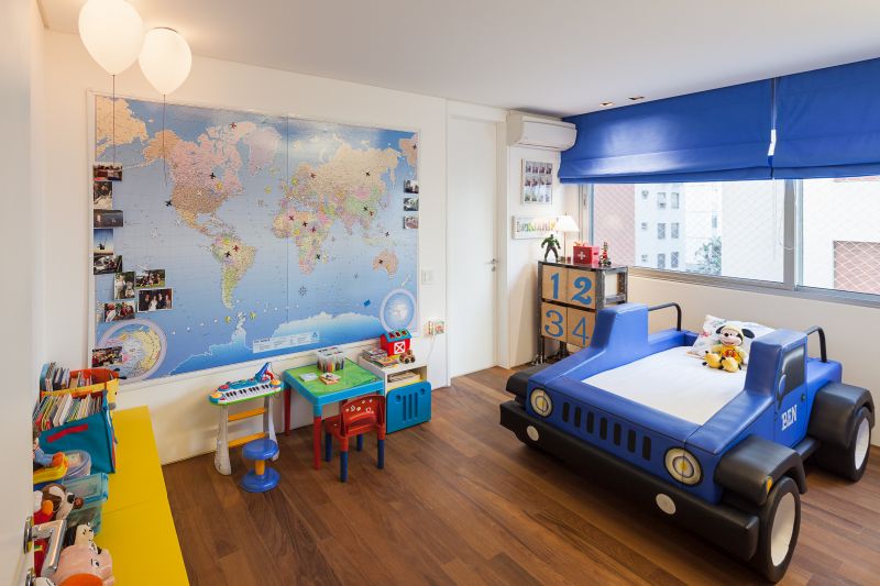 Kids room with a bed in shape of a car and world map on the wall