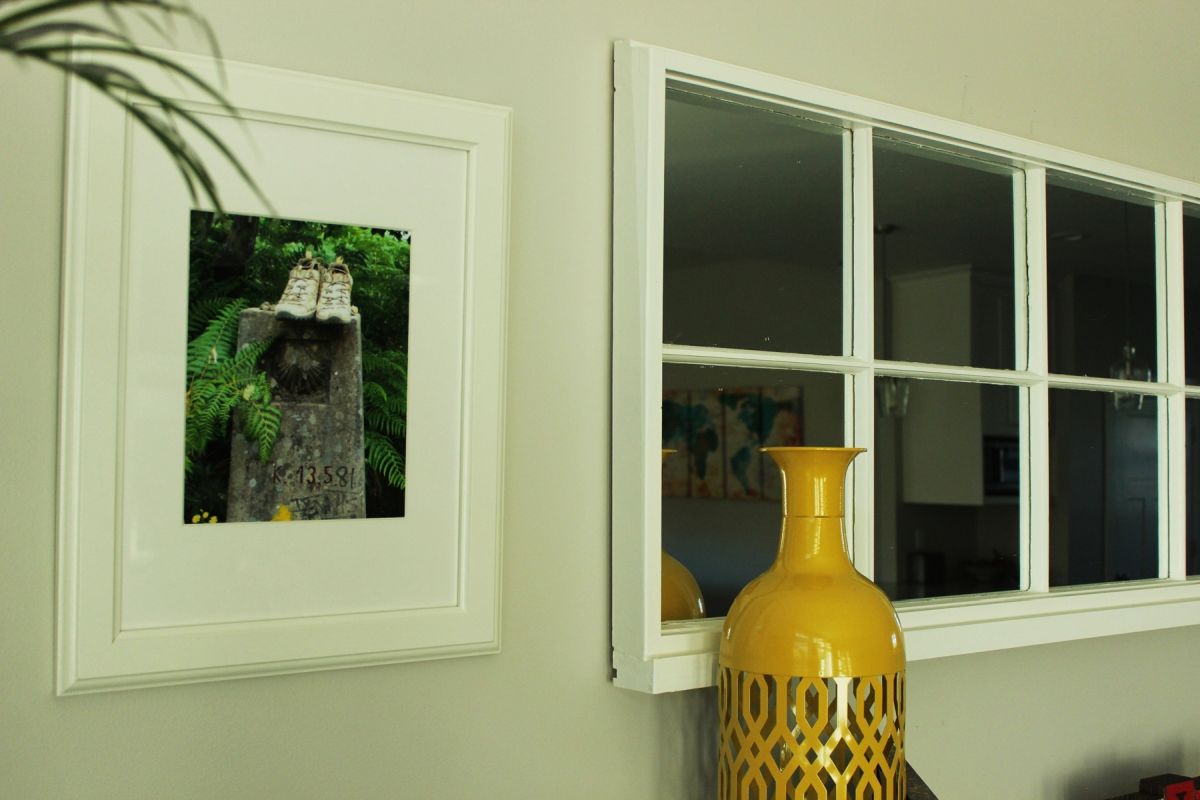large mirror is framed in antique wooden