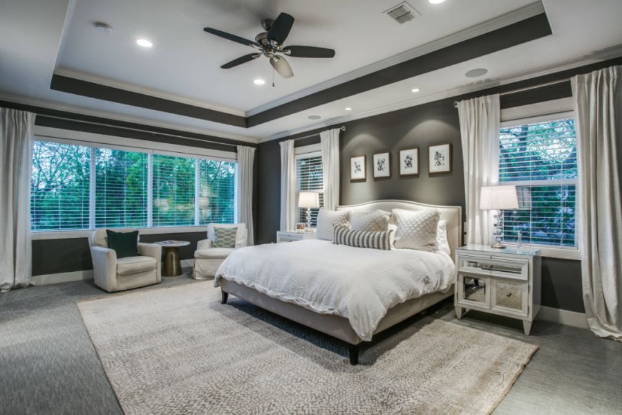 Large transitional master carpeted and gray floor bedroom