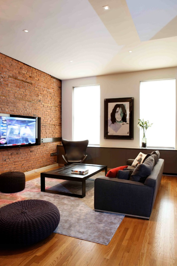 Living room exposed bricks wall behind tv