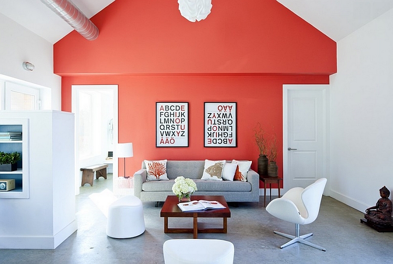 Living room with a bright coral accent wall and iconic furniture