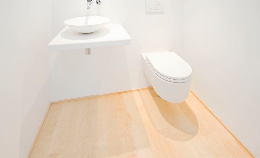 Minimalist bathroom with wall mounted toilet