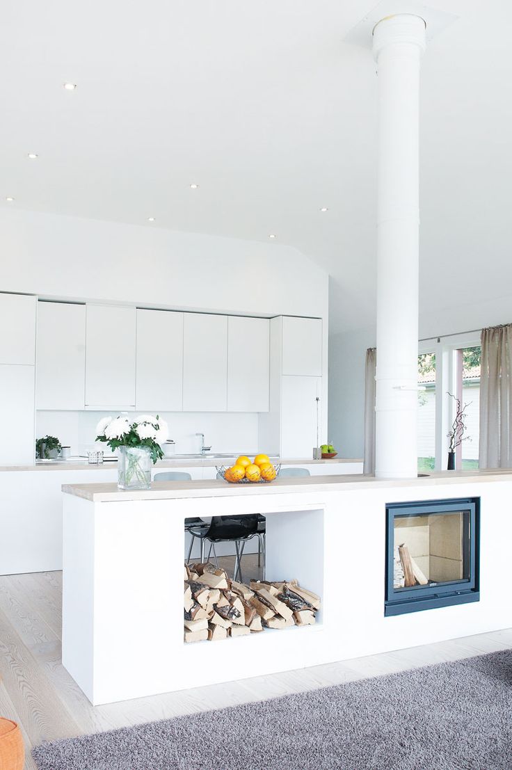 Modern kitchen island fireplace and wood storage