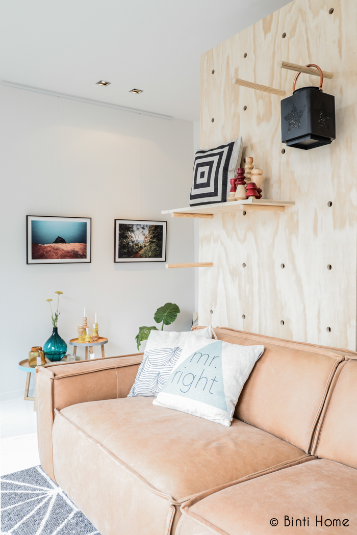 oversized-pegboard-wall-behind-sofa