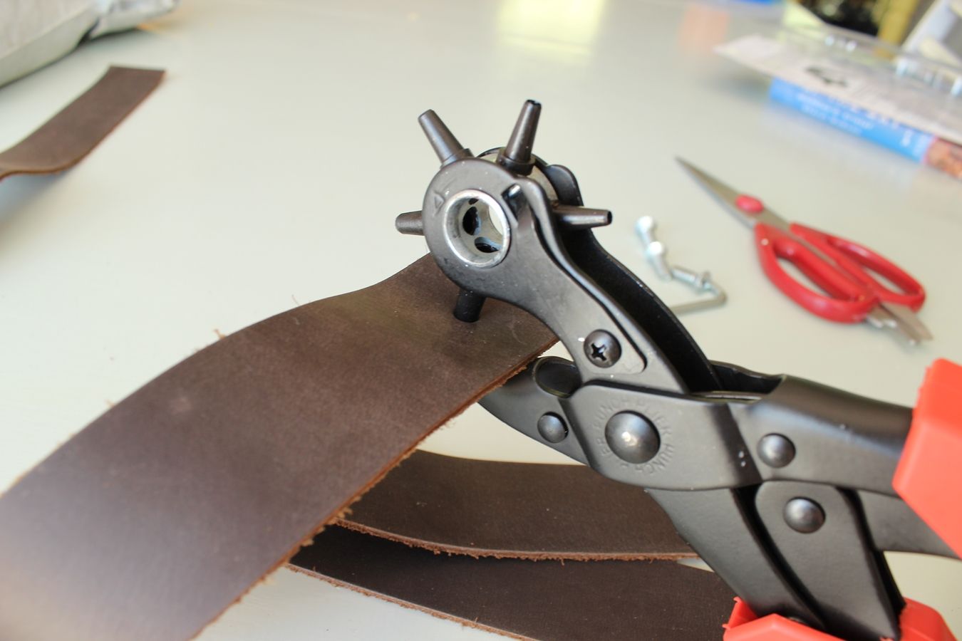 Punch a hole in the leather