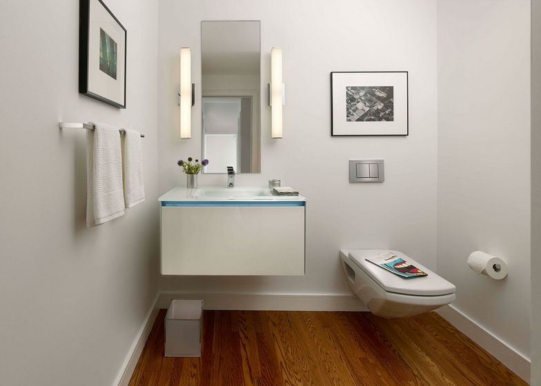 Small poweder room hanging wall art and floating toilet