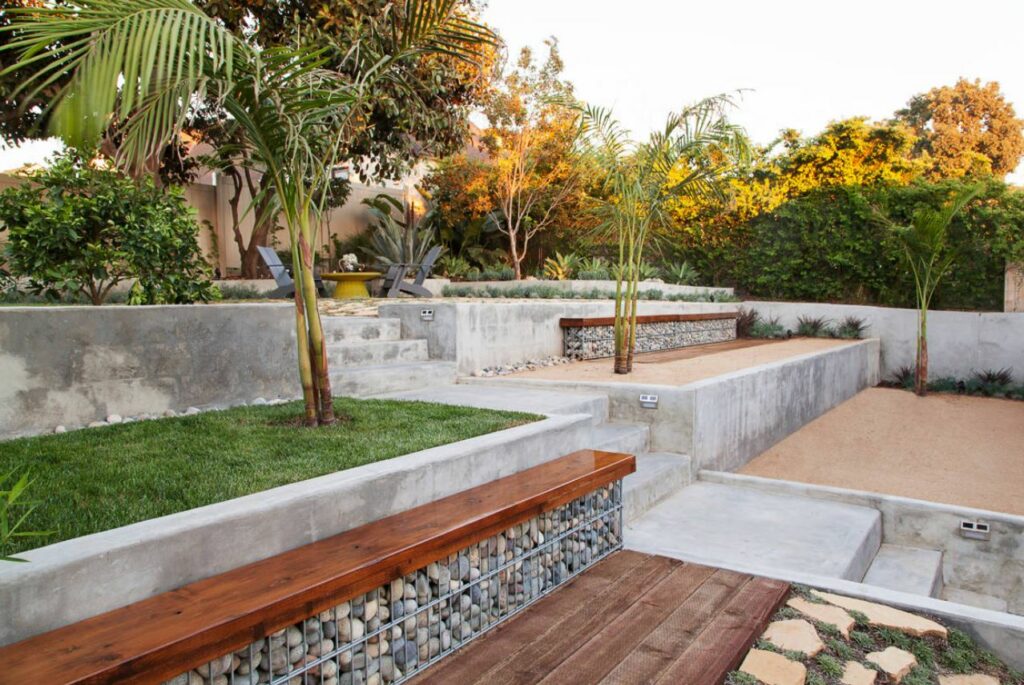 Stone retaining wall with grass and bench 1024x685