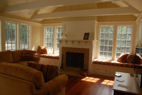 Traditional living room with fireplace and window seating above