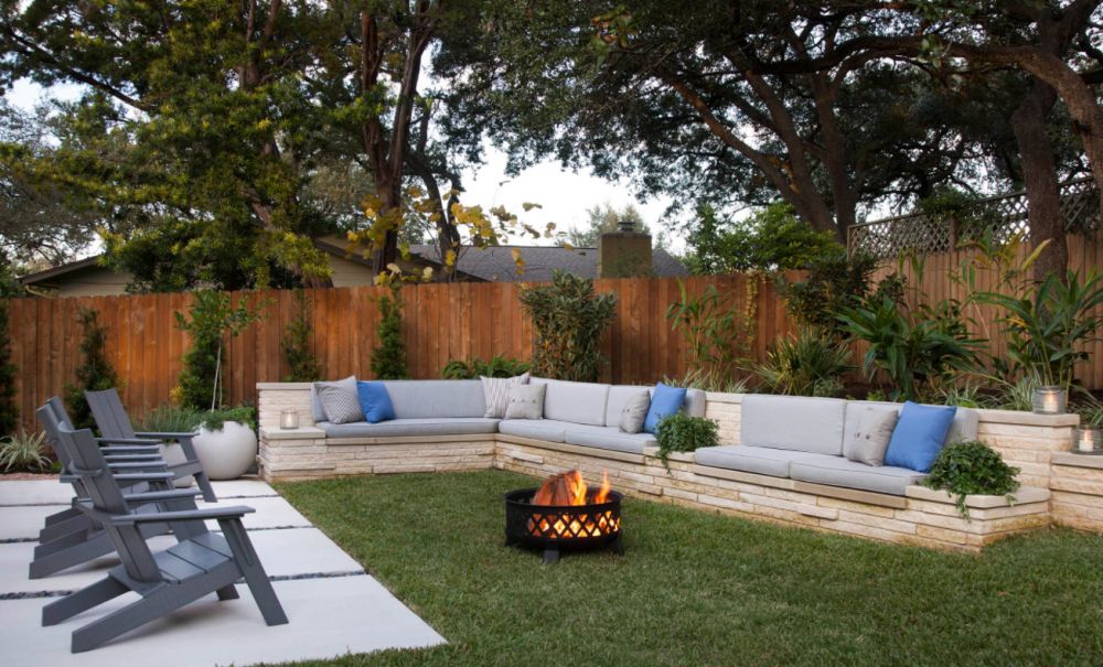 Transitional partial sun backyard landscaping in Austin with a fire pit