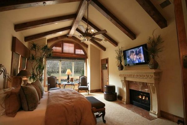Tv above the fireplace exposed beams