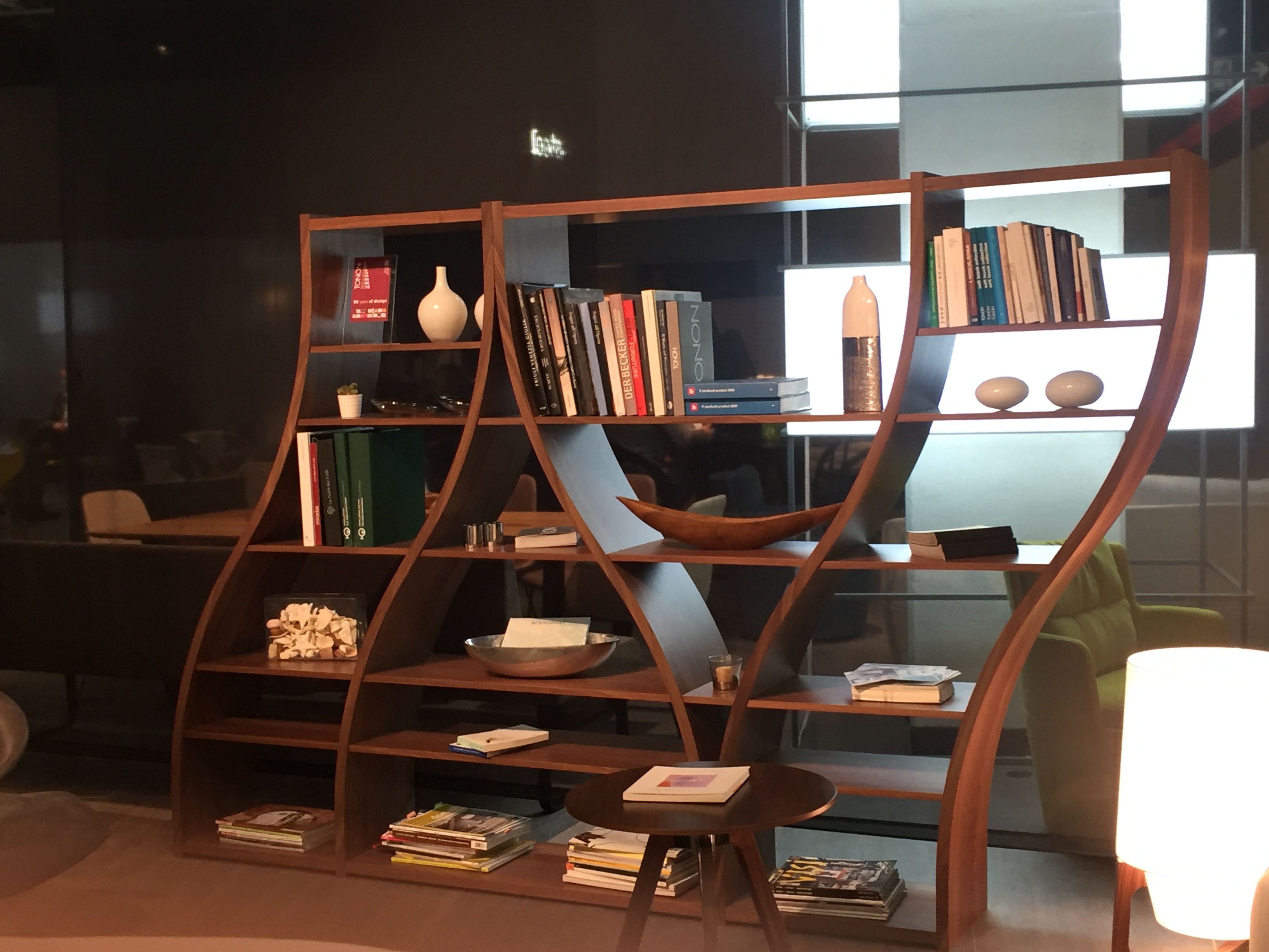 Undulating shelves and curved design for wall divider with books