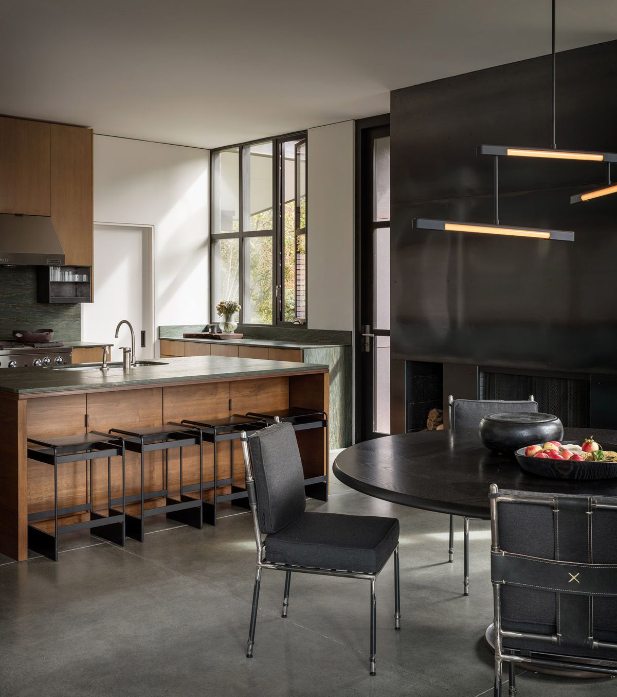 Waterfront home in the Pacific Northwest by Olson Kundig kitchen island with seating