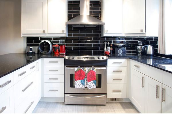 White kitchen cupboards black backsplash