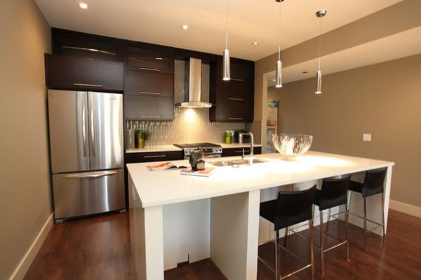 A kitchen island that’s a prep area on one side and a table/bar on the other