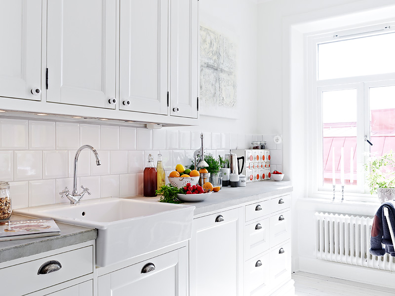 White kitchen subway tiles and farm sink