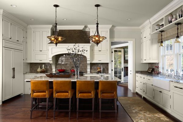 White kitchen with bronw leather chairs