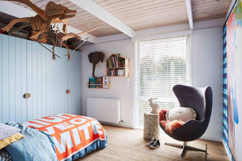 Wooden dinosaur hanging from the ceiling in the childrens room