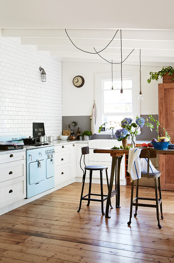 Wooden floor and subway tiles love the hanging lighting cords