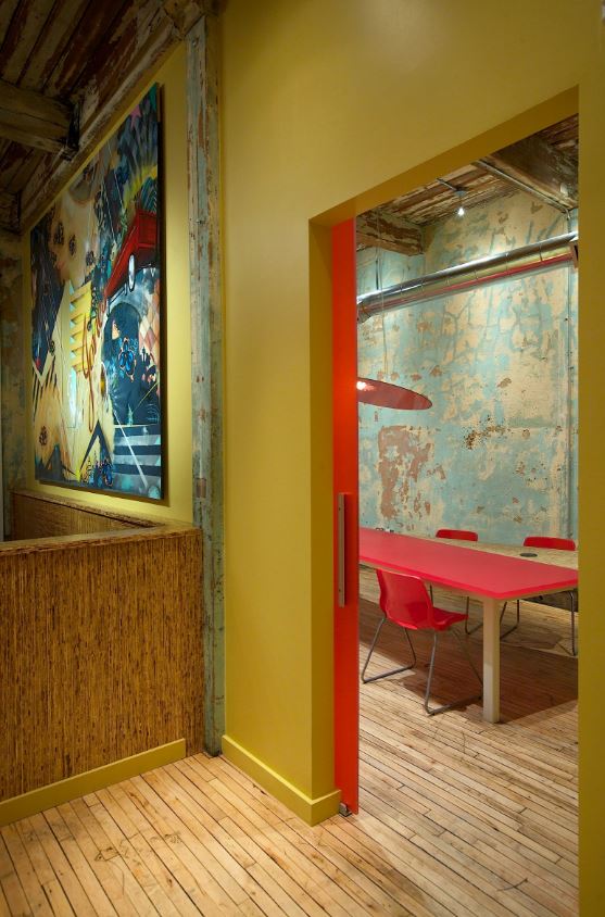 Yellow and red room with wood floors plaster walls