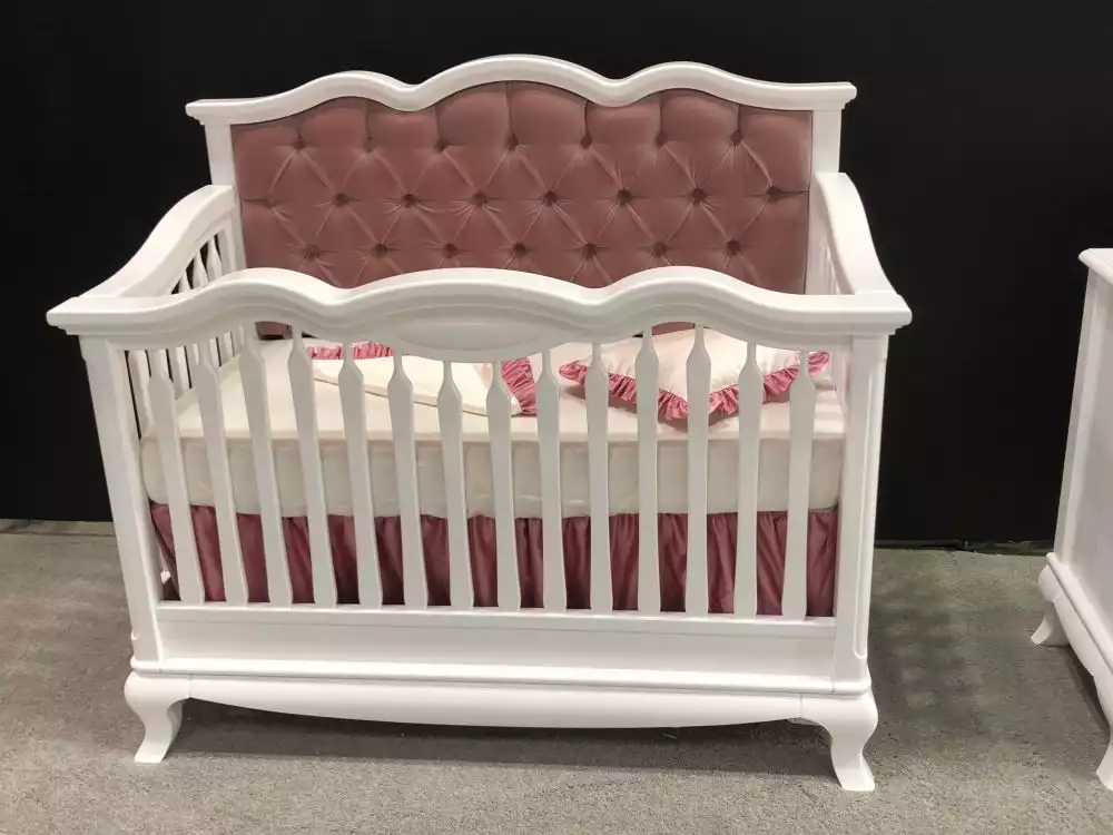 Baby crib with tufted pink shade color