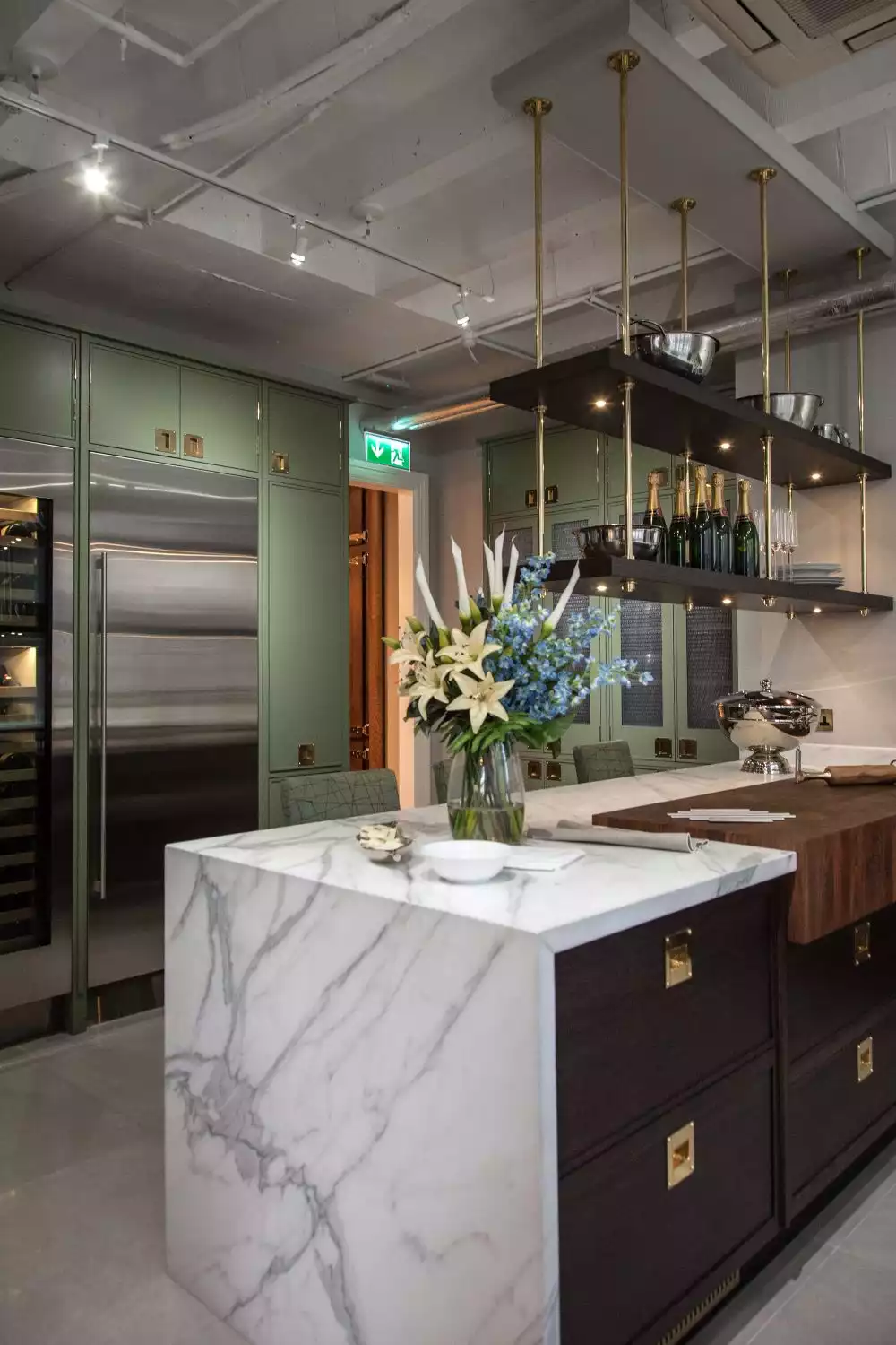 Beautiful kitchen with gold accents and marble waterfall countertop