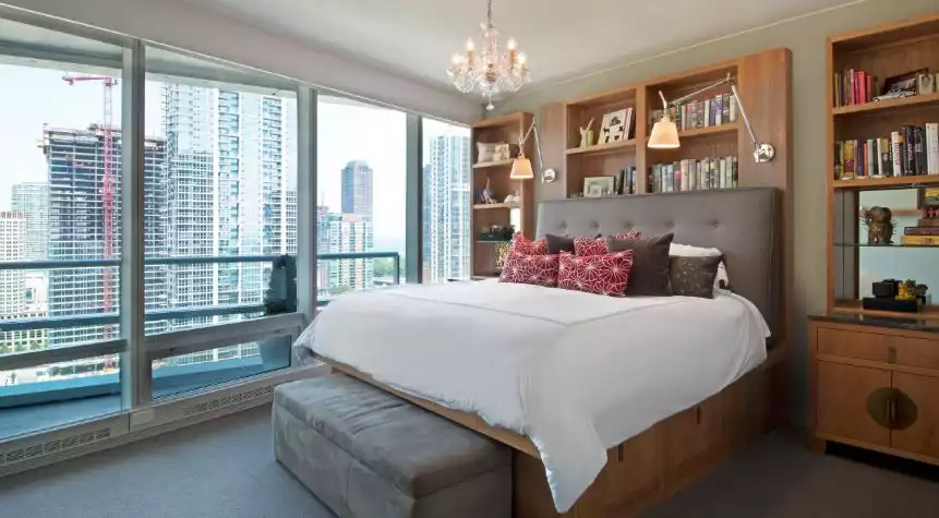 Bedroom bookcase storage behind bed