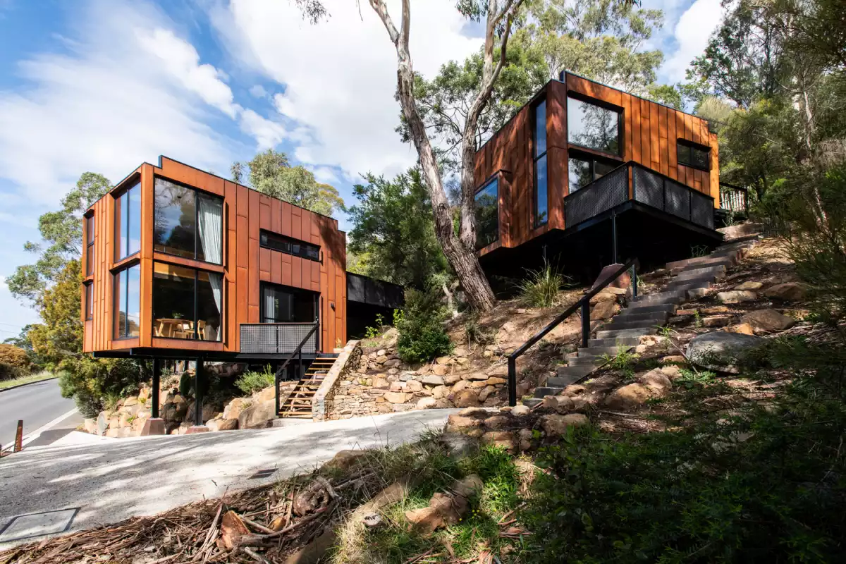 The simple geometry, reduced size and weathered steel exteriors make it easy for the buildings to blend into the landscape