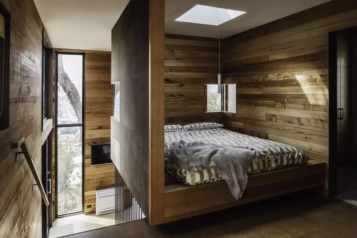 The sleeping areas have horizontal wood paneling that creates a very warm and cozy decor