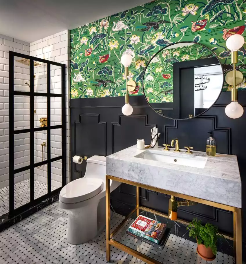 Black and white bathroom accented by green floral wallpaper