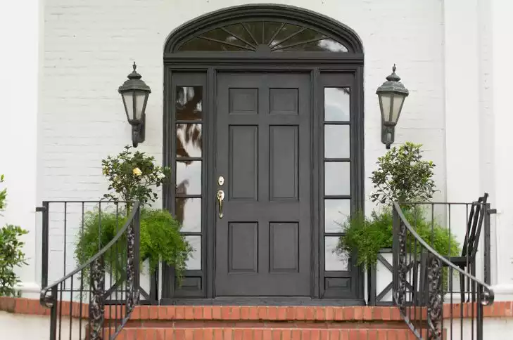 Bricks stairs and black front painted door