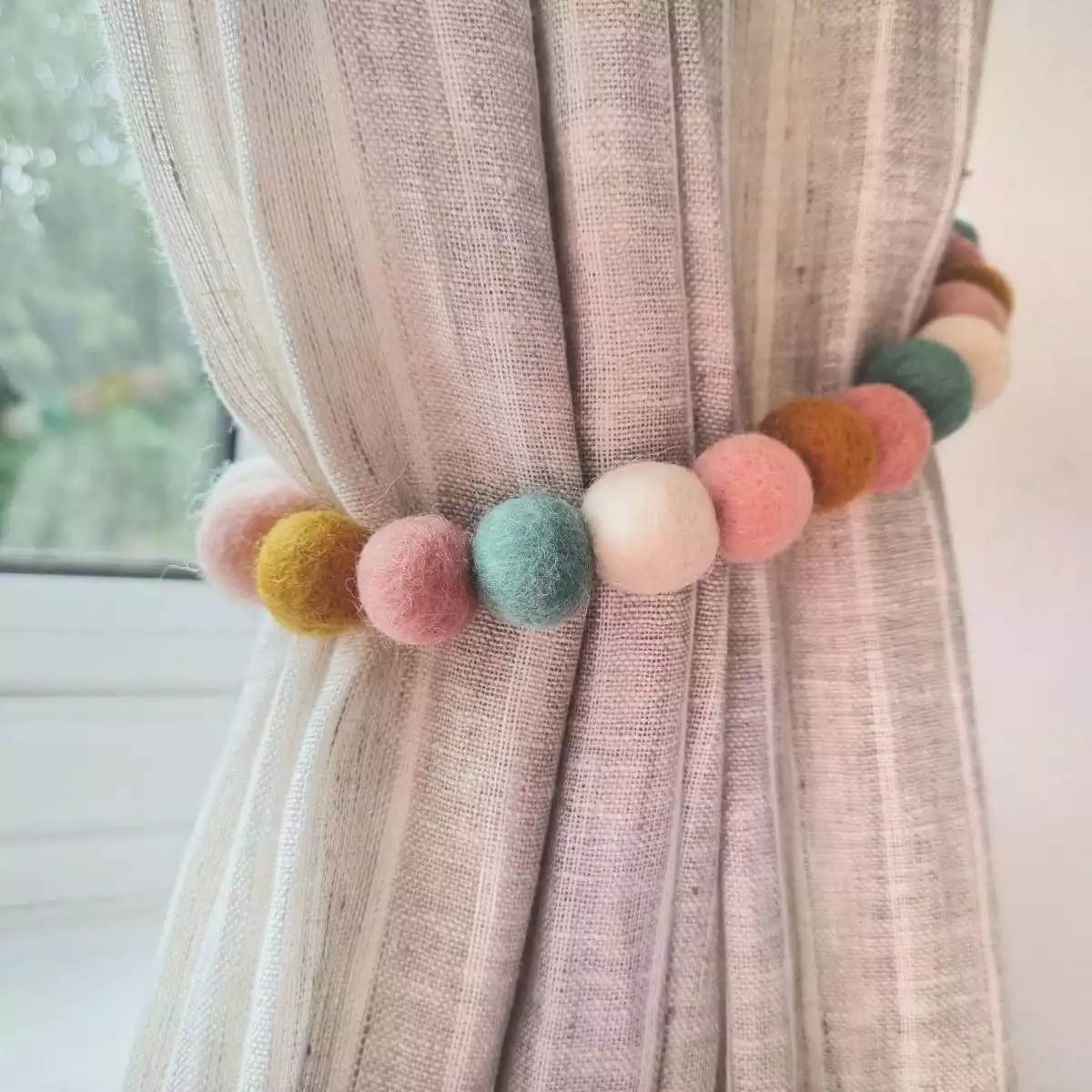 Colored pom pom tie-back