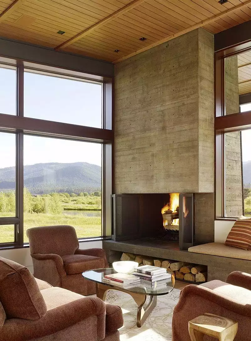 Concrete fireplace Peaks View Residence by Carney Logan Burke Architects