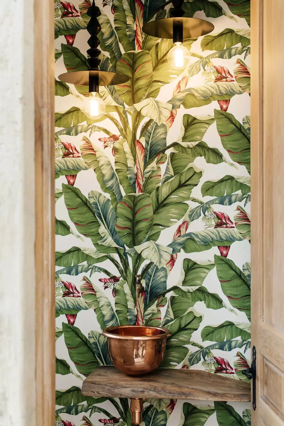 A variety of indoor plants complemented by themed artwork give the house a fresh, nature-infused vibe