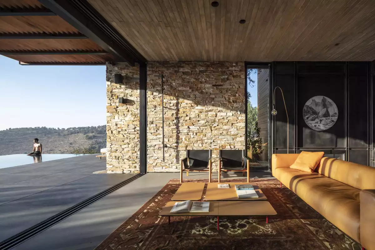 The stone floor makes the transition between the living room and the deck feel seamless