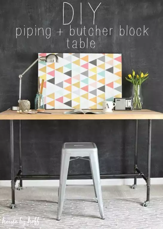 A cool desk with a metal pipe frame and wheels