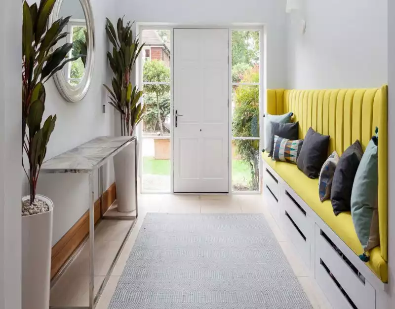 Entryway with yellow storage bench