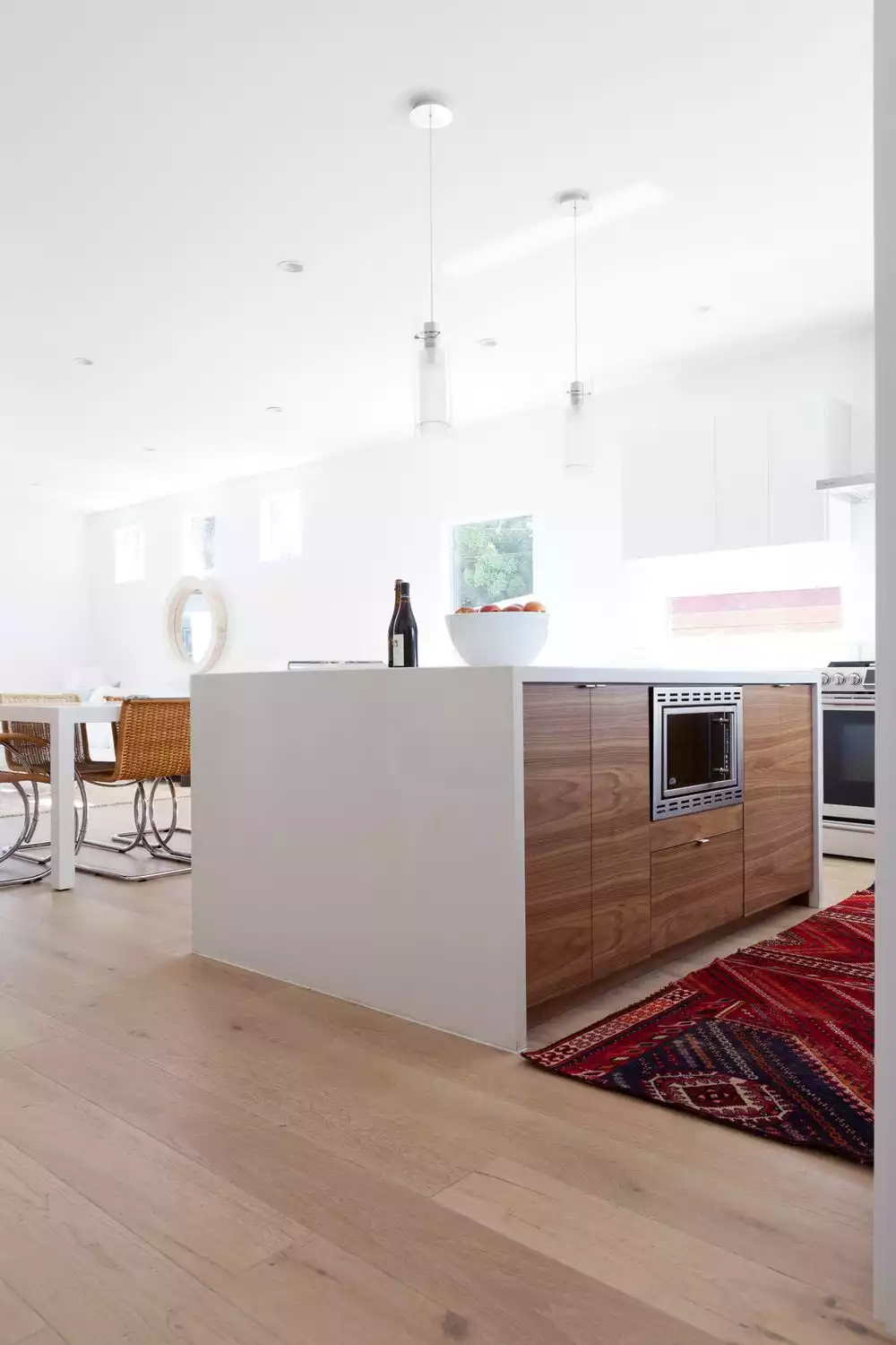 Kitchen island in wood with white shell countertop waterfall style