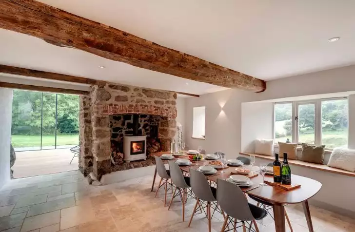 Large wood ceiling beam with a stone fireplace design