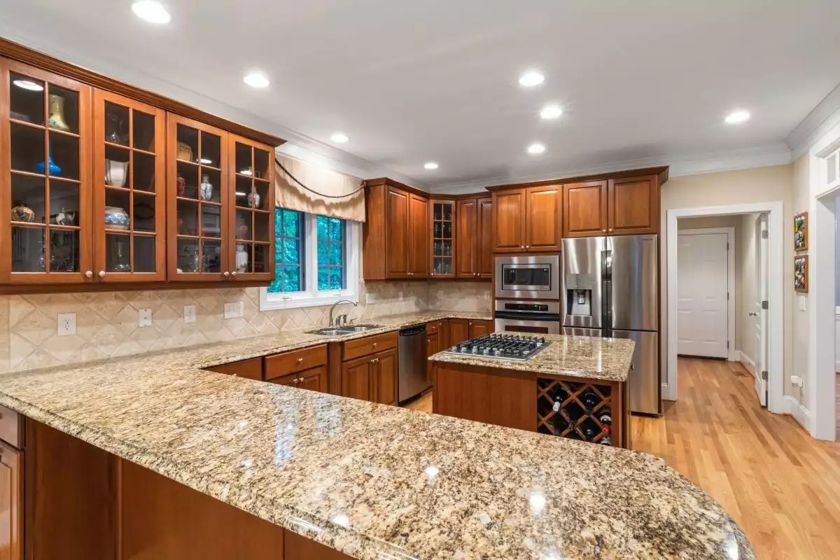 Light Tan Granite Counters with Wood Cabinets